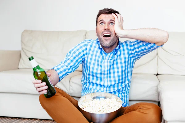 Sports fan watching game on tv — Stock Photo, Image