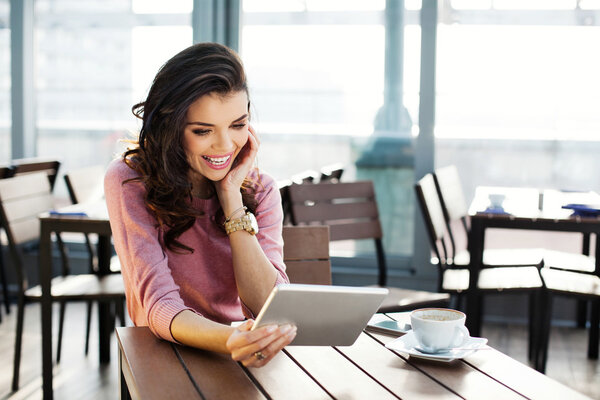 Woman with her tablet in a cafe