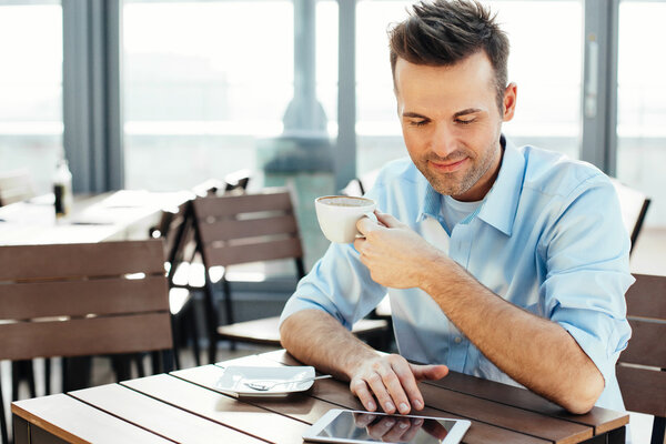 Man reading news on his tablet