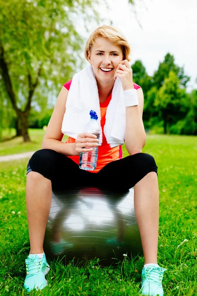 Woman sitting on a Pilates ball — Stock Photo, Image