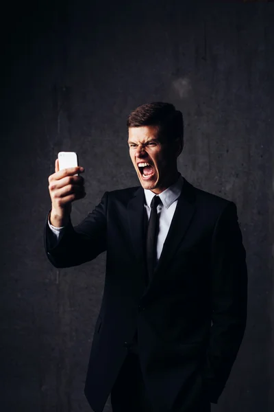 Businessman looking at smartphone — Stock Photo, Image