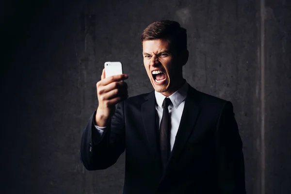 Businessman looking at smartphone — Stock Photo, Image