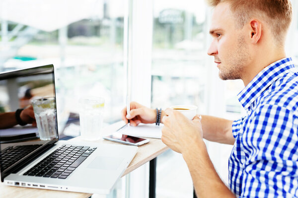 Man sitting in front of a laptop