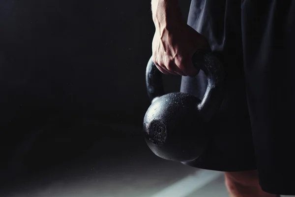 Hand holding a kettlebell — Stock Photo, Image