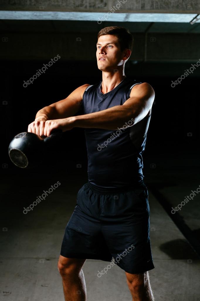 Muscular athlete with a kettlebell — Stock Photo © baranq 68822063