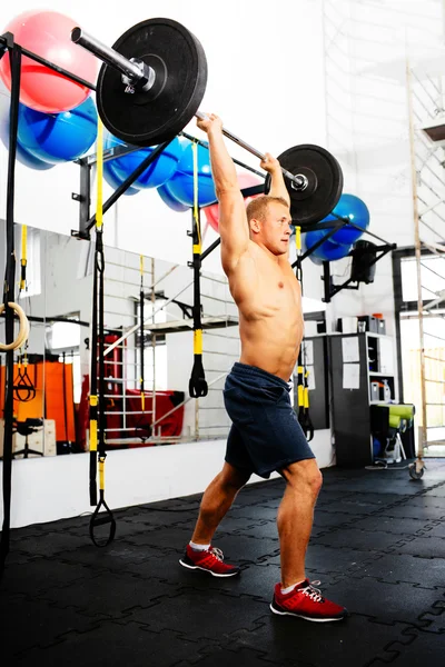 Athlete pushing the barbell — Stock Photo, Image