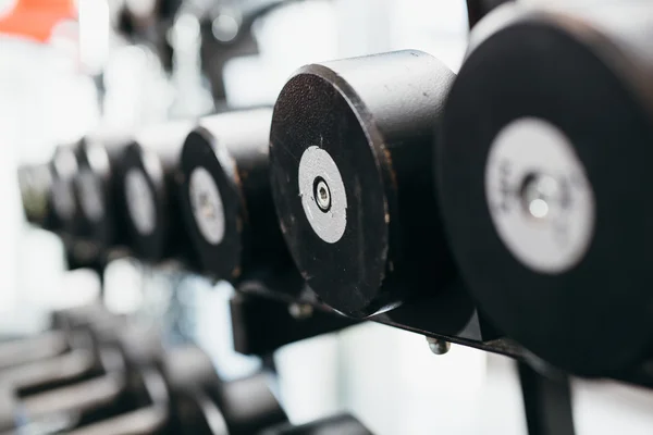 Dumbells set in gym — Stock Photo, Image