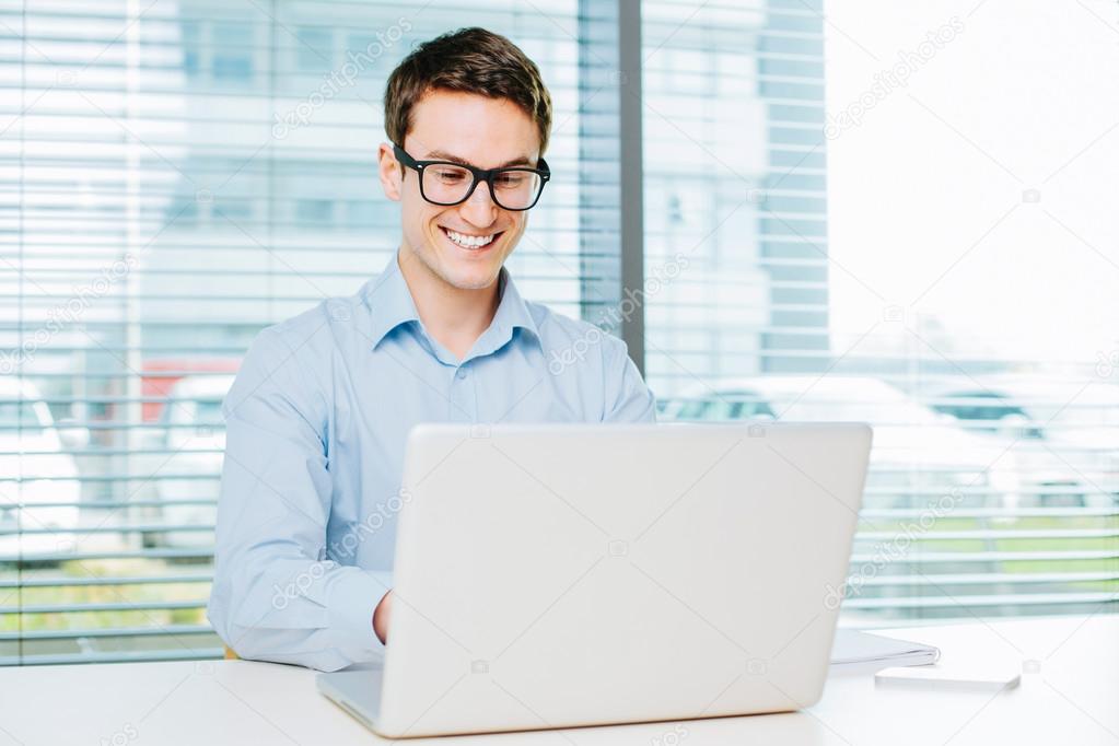Young man typing on laptop