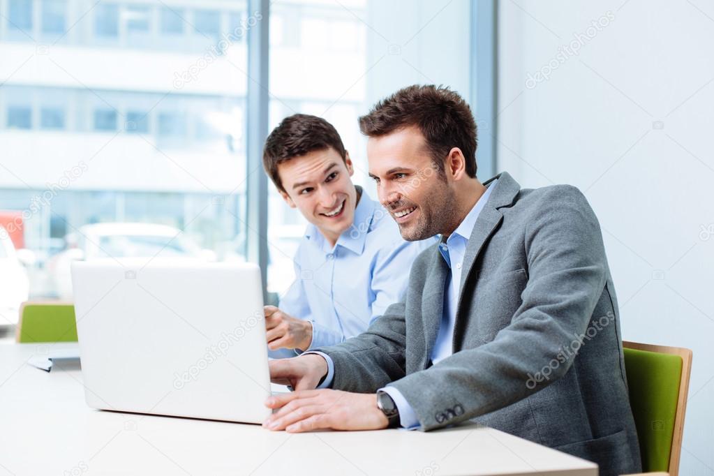 Two businessmen working on laptop