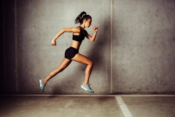 Slim attractive sportswoman running — Stock Photo, Image