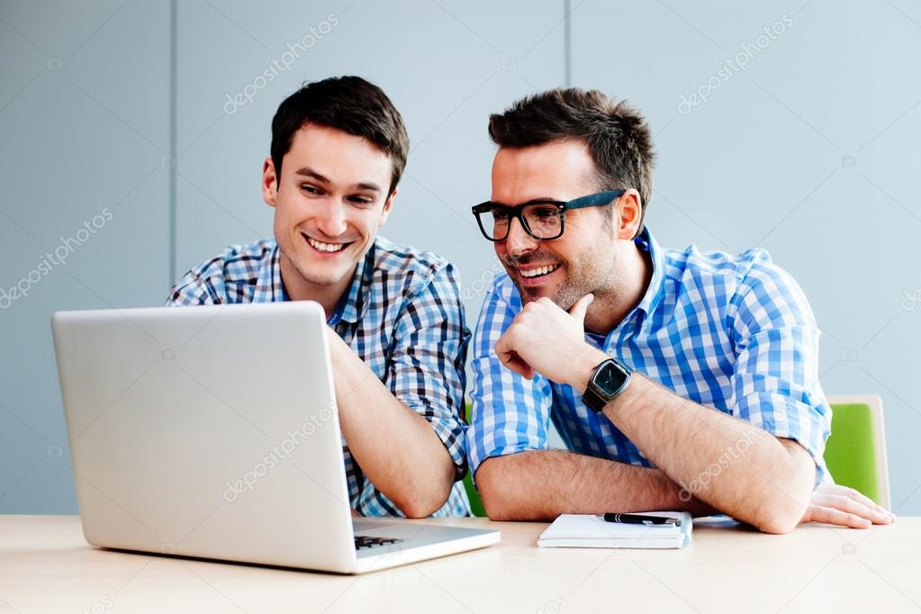Webdesigners looking at their project on laptop
