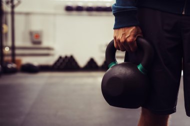 Adam holding kettlebell