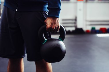 Adam holding kettlebell