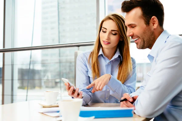 Two professionals trying a new mobile app — Stock Photo, Image