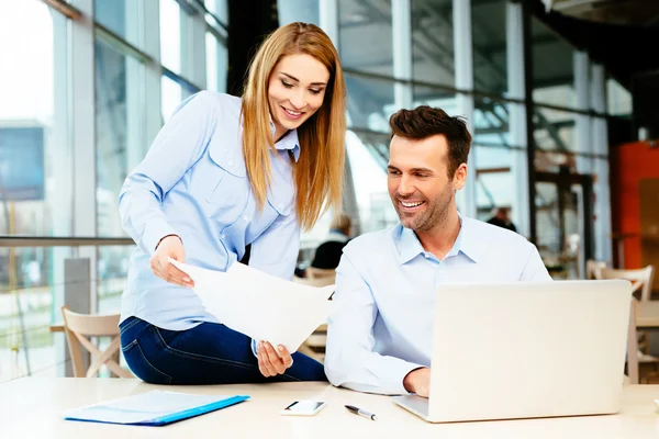 Young business partners looking at sales data — Stock Photo, Image