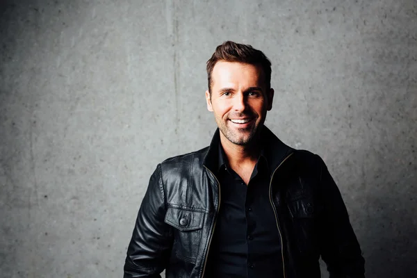 Happy handsome man in leather jacket — Stock Photo, Image