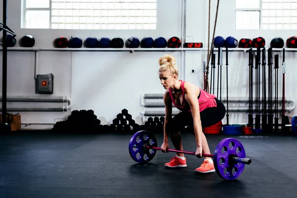 Женщина тренируется тягач с штангой — стоковое фото