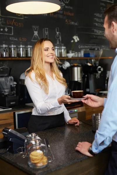 Cheerful barista giving coffee to client — Stock Photo, Image