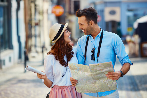 Happy couple of tourists in the city