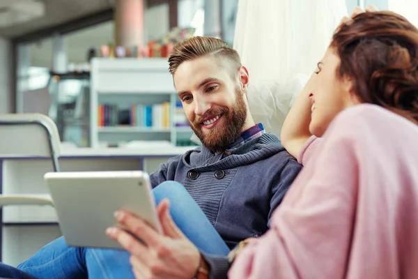 Hipster with his girlfriend browsing internet — Stock Photo, Image