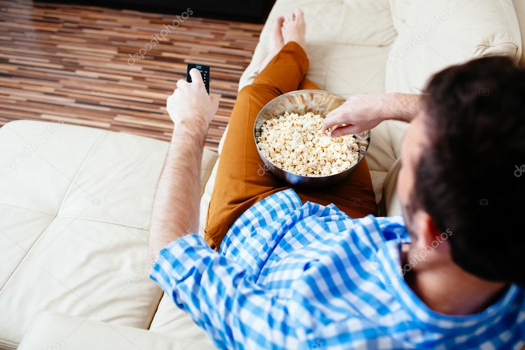 man relaxing in front of TV