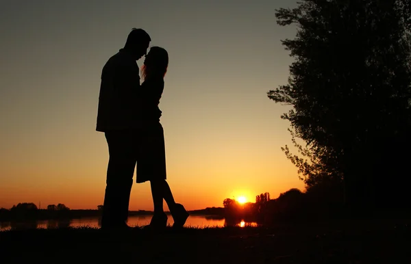 Silhouet van paar verliefd bij zonsondergang — Stockfoto