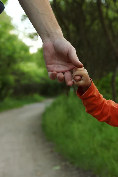 Parent holding child's hand — Stock Photo, Image