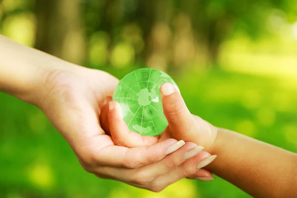 Glass globe in hands — Stock Photo, Image