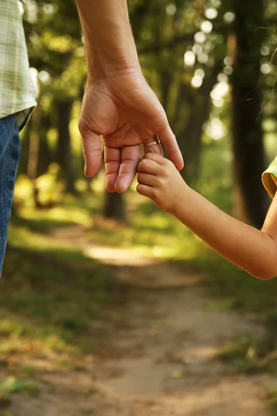 Parent holds small child — Stock Photo, Image