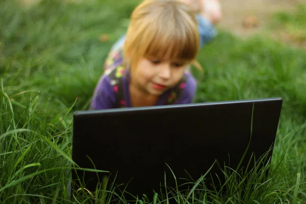 Beautiful little girl with laptop Stock Photo