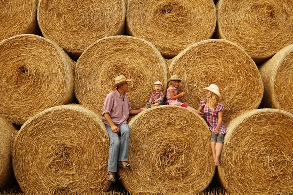 Happy family on haystacks — Stock Photo, Image