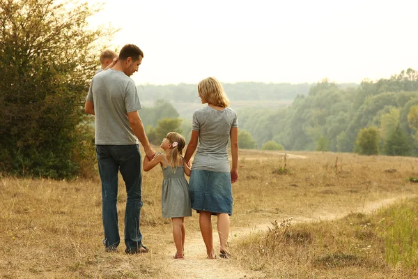 Young family on nature — Stock Photo, Image