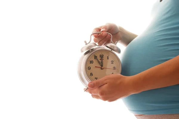 Kobieta w ciąży z zegarem — Zdjęcie stockowe