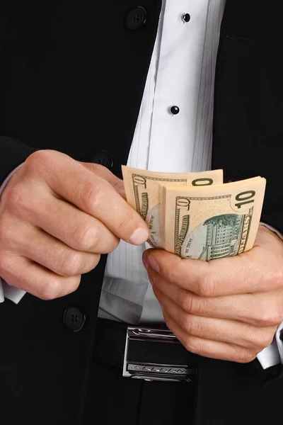 Business man holding money on white background