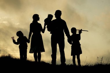 Doğuştan çocuklu mutlu bir ailenin silueti.