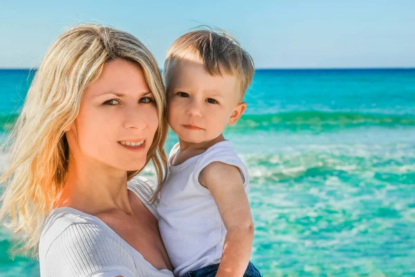 happy parent with child at the sea shore in nature