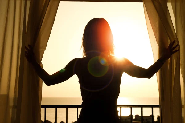 silhouette of a women near the window on hotel