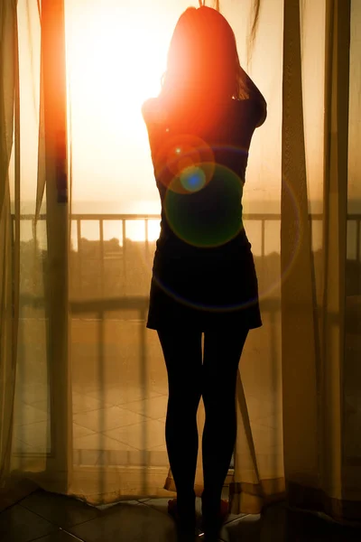 nice silhouette of a women near the window on hotel