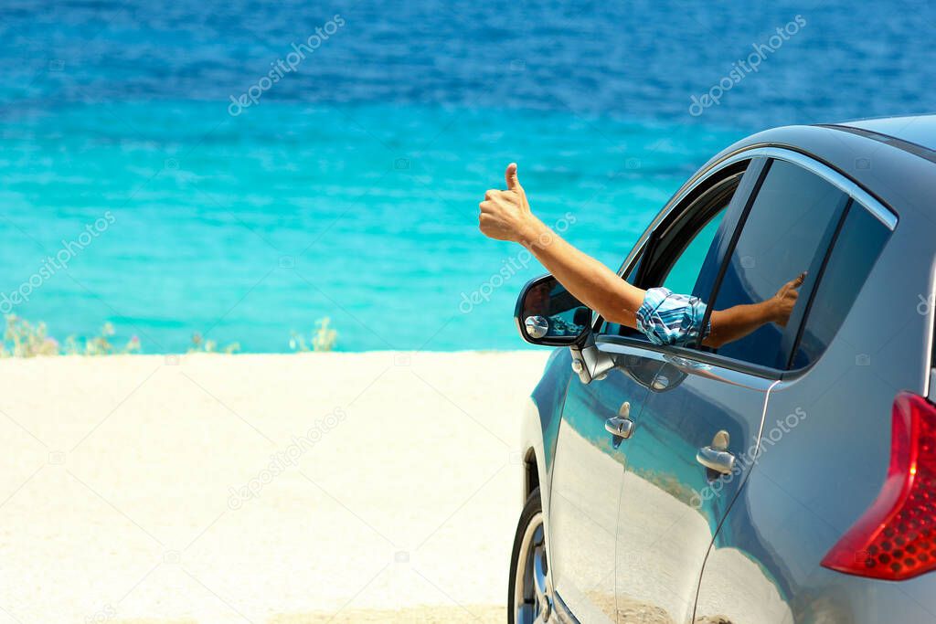 happy driver in car at sea in summer concept freedom and happy