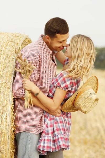 Casal abraçando perto palheiro — Fotografia de Stock