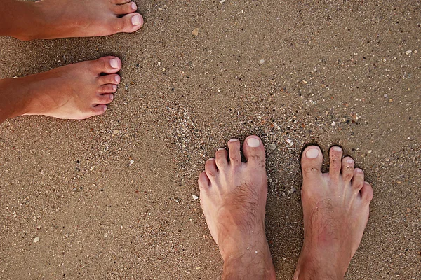 Voeten van verliefde paar op het strand — Stockfoto