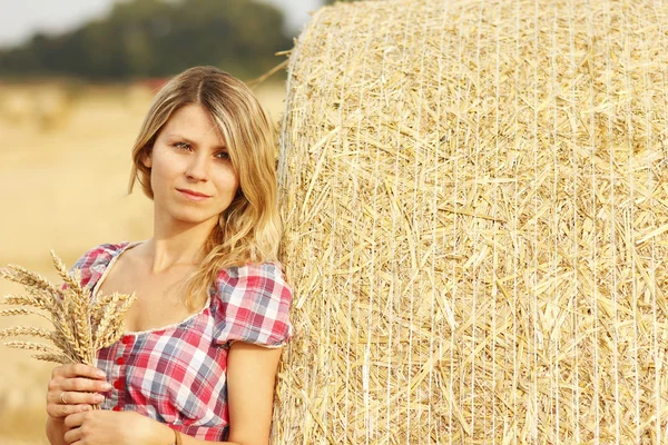 Young girl near haystack — Stock Photo, Image