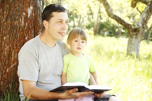 Padre con hija pequeña leyendo — Foto de Stock