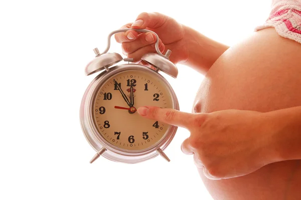 Mujer embarazada sosteniendo reloj — Foto de Stock