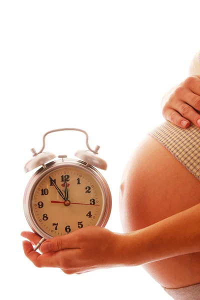 Femme enceinte tenant horloge — Photo