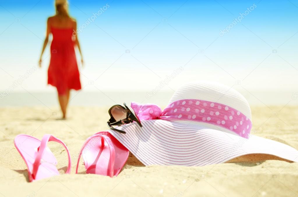 Girl with slippers on beach