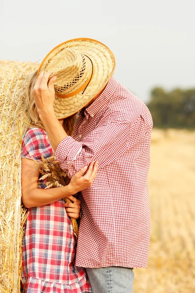 Young couple in love near haystack — Stock Photo, Image