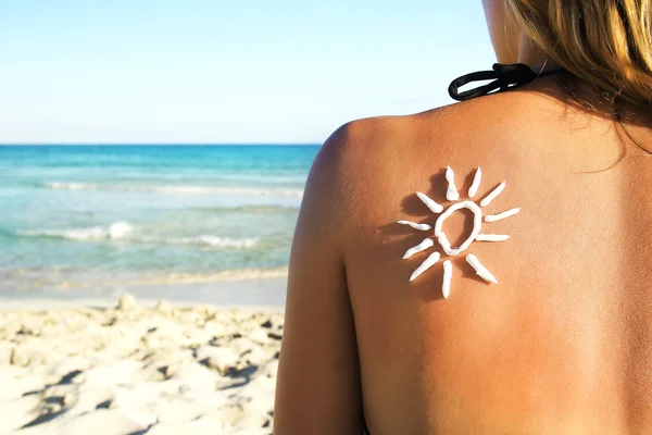 Sun shaped cream on back — Stock Photo, Image