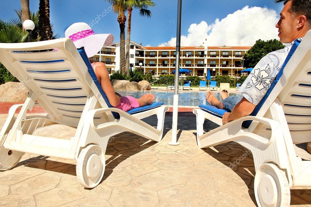 couple on sun loungers