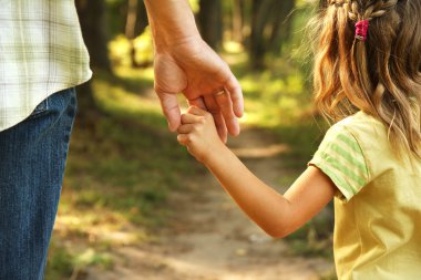 parent holds hand of child clipart
